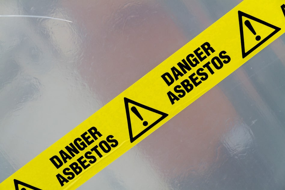 Danger Asbestos yellow warning tape close up